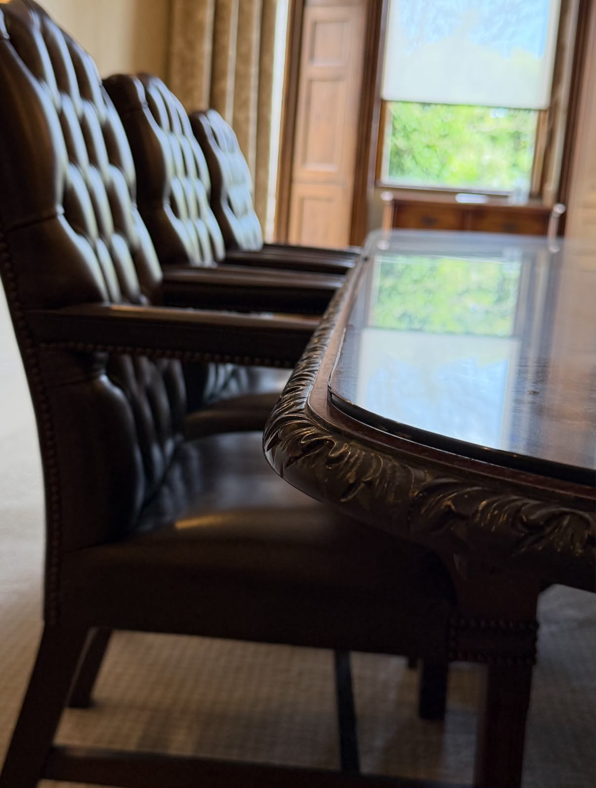 Leather chairs beside the carved boardroom table